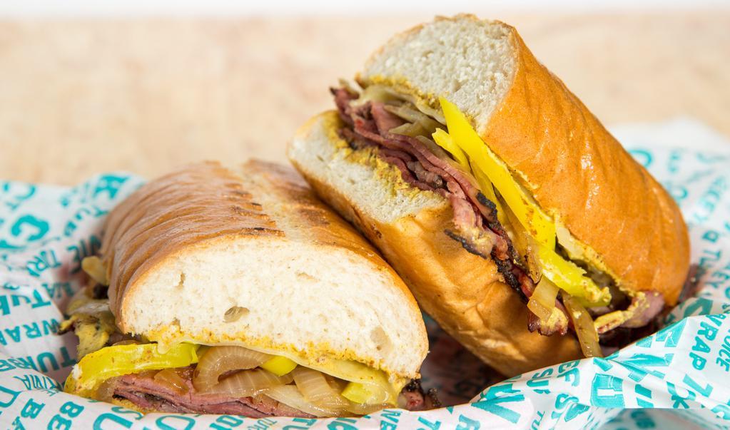 Left Coast Pastrami · Hot pastrami with grilled onions, dijon mustard, pepperoncini peppers and melted swiss cheese on a toasted French baguette.