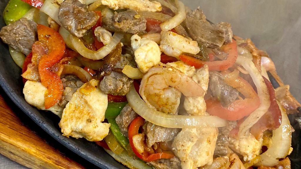 Mixed Fajitas · Sizzling platter of grilled steak or chicken and shrimp, mixed with bacon, bell peppers, onions, and tomatoes.