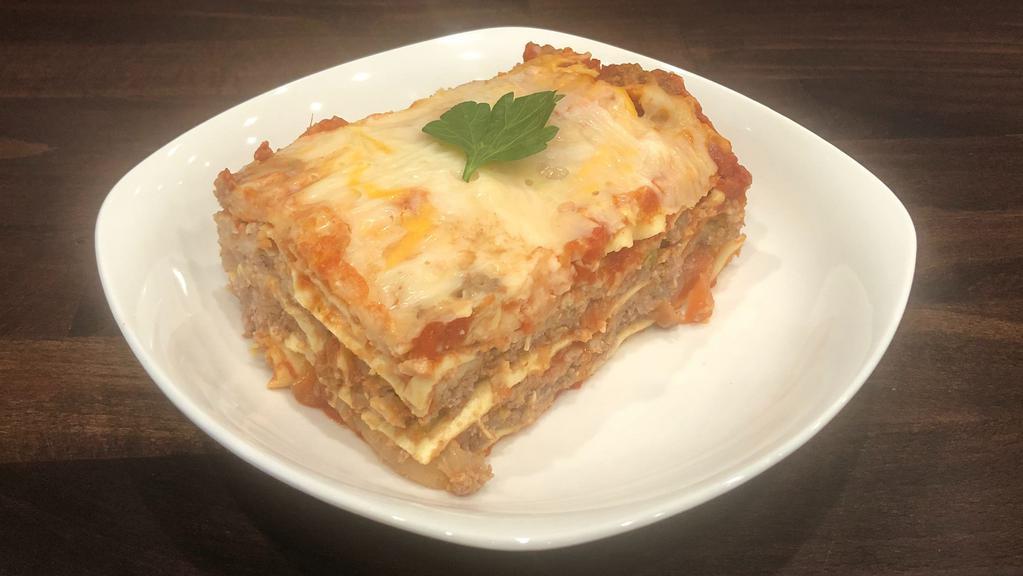 Lasagna · Layers of Pasta, Swiss Cheese, Parmesan Cheese with Meat Sauce.
