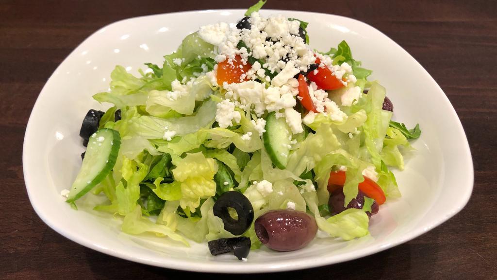 Greek Salad · Romaine Hearts, Spinach, Persian Cucumber, Grape Tomatoes, Kalamata Olives,  Sliced Black Olives, Mediterranean Feta Cheese, Balsamic Vinegar.