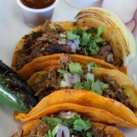 3 Birria Tacos Con Consome · 3 BIRRIA TACOS ON  YELLOW CORN TORTILLA WITH BIRRIA MEAT TOPPED WITH CILANTRO AND ONION SERV...