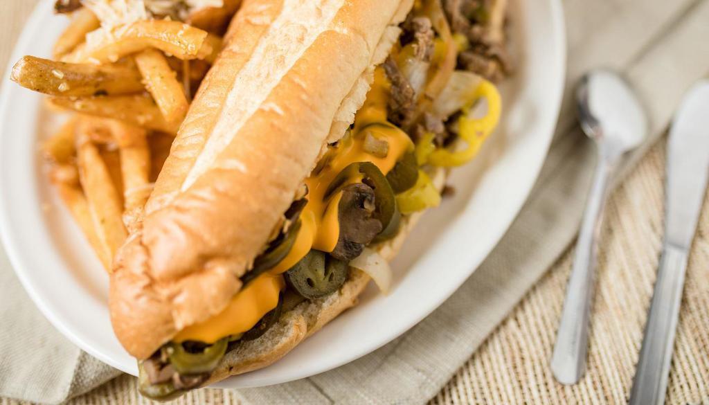 Mels “Original Cheese Steak” Sandwich · This one has it all! Served on our  hoagie-style bun with tender-sliced, grilled sirloin steak topped with sautéed mushrooms, grilled onions, and layered with cheese sauce, topped off with jalapeño and pepperoncini.