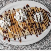 Chocolate Chip Hotcakes · Full stack with Ghiradelli chocolate chips melted throughout.  Topped with whipped cream.