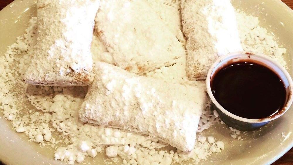 Beignets · 4 new Orleans style doughnuts topped with powdered sugar.