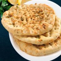 Garlic Naan · Flat bread sprinkled with crushed garlic, cheese and baked in tandoor oven.