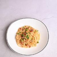 Spaghetti Carbonara · Smoked bacon, egg yolk, cream, peas and Parmesan cheese.