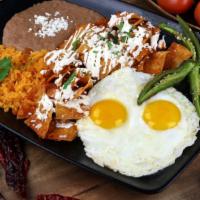 Chilaquiles Clásicos · A traditional Mexican breakfast! Your choice of green or red chilaquiles made with house sec...