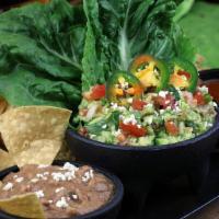 Guacamole , Chips & Beans · The perfect combination: freshly made guacamole served with delicious refried beans, tomatil...