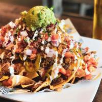 Rr Loaded Nachos · Crispy tortilla chips smothered with a house-made Russian River beer cheese, bacon, guacamol...