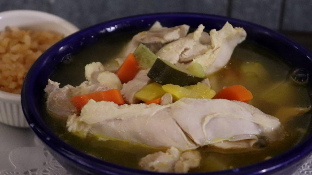 Caldo De Pollo · Vegetable soup with chicken, served with rice