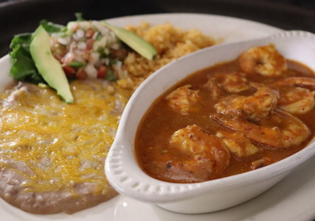 Camarones A La Diabla · Jumbo shrimp sautéed in jalapeño butter and fresh garlic them covered in our spicy diabla sauce. Served with rice and beans garnished with pico de gallo and fresh hass avocado slices. Your choice of corn or flour tortillas.