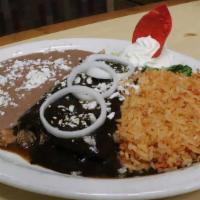 Enchiladas De Mole · Two grilled corn enchiladas filled with shredded chicken made with our freshly mole sauce. S...