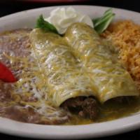 Chile Verde · Two soft corn tortillas stuffed with shuck pieces of pork and topped with green tomatillo sa...