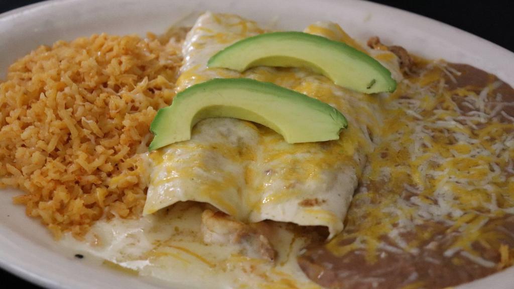 Shrimp Enchiladas  · Two flour enchiladas filled with shrimp and with a sauvignon blanc enchilada sauce. Served with rice and beans. Garnished with avocado slices.