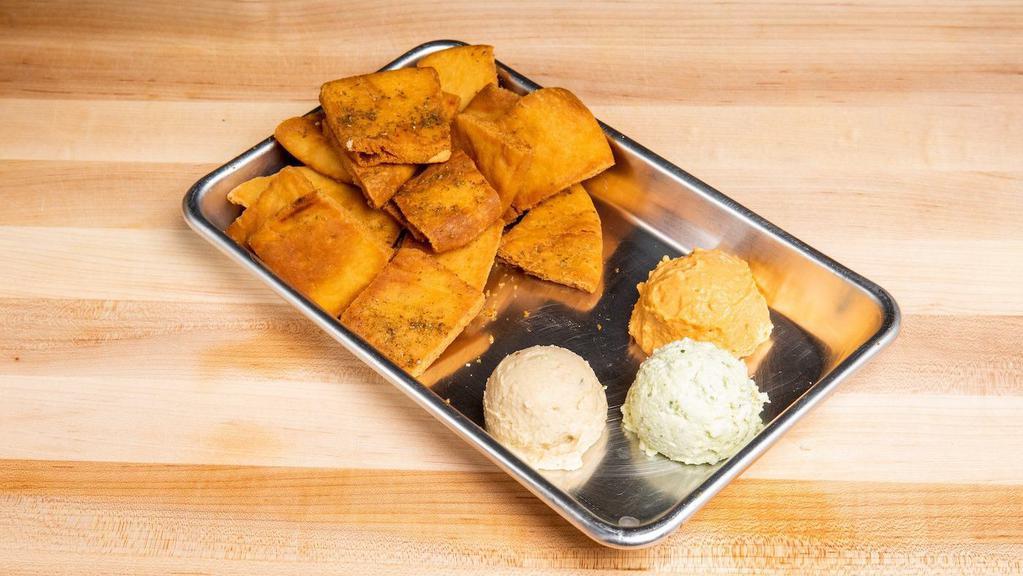 Hummus & Pita Chips · Housemade organic hummus served with a side of pita chips.