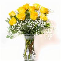 Unforgettable Dozen Rose Arrangement Yellow  · Dozen yellow roses with babies breath and greens arranged in clear vase.