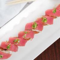 Hawaiian Roll · Tuna, green onion and house special sauce over roll with spicy tuna. Spicy.