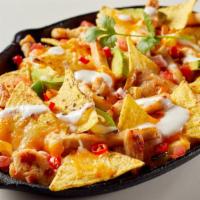 Chicken Breast Super Nachos · Hearty chicken breast, refried beans, and onions topped with melted cheddar cheese and sour ...