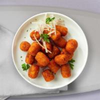 Spiced Tots · (Vegetarian) Shredded Idaho potatoes formed into classic tots, and fried until golden brown ...
