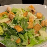 Caesar Salad · Crisp Romaine lettuce topped with fresh Parmesan reggiano cheese and croutons with our house...