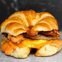 Croissant, Bacon, Sausage, Egg & Cheddar Sandwich · 2 scrambled eggs, melted Cheddar cheese, smoked bacon, breakfast sausage, and Sriracha aioli...