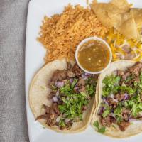 Breakfast Tacos · 2 corn tortillas filled with scrambled eggs, meat of choice, cheese, topped with guacasalsa.