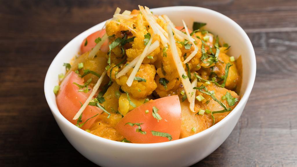 Aloo Gobi (Vegan) · Fresh cauliflower and potatoes cooked with fresh onions, herbs and spices.