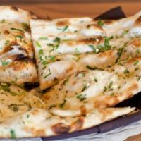 Garlic Naan · Leavened white bread topped with garlic & cilantro baked to order in the tandoor oven.