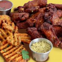 Two Dozen Chicken Wings Pack · Marinated Chicken Wings, Served with Waffle Fries, Choice of Two Sauce.