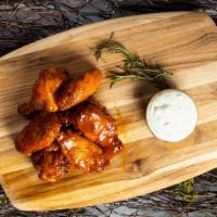 Baffling Buffalo Wings · Organic chicken wings breaded, fried until golden brown, and tossed in buffalo sauce. Served...