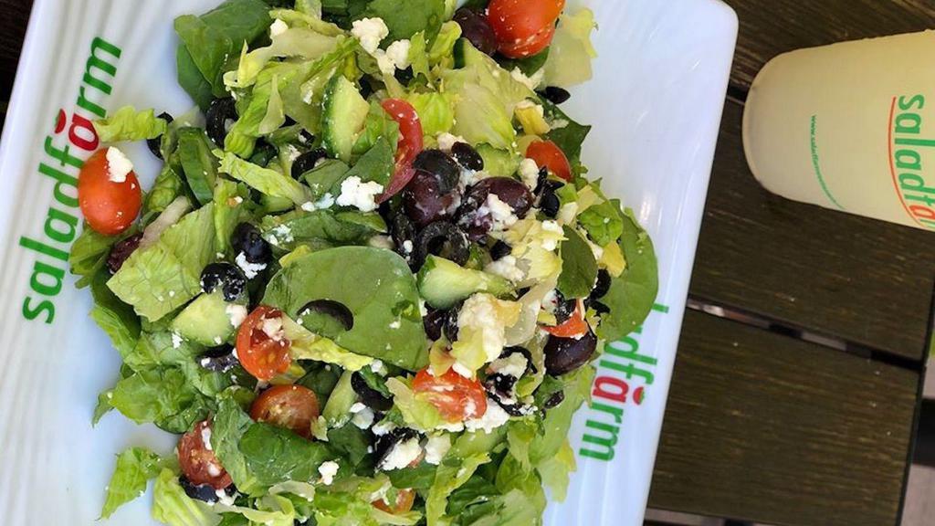 Greek Salad · Crisp romaine hearts, mixed with organic baby spinach, Persian cucumbers, grape tomatoes, kalamata olives, sliced ripe olives and Mediterranean feta cheese, tossed with a light balsamic reduction.