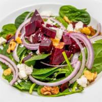 Sweet Beets · Spinach, goat cheese, walnuts, red onions, honey lime dressing.