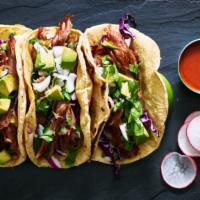 Deep Fried Pork(Carnitas) Tacos · Fried pork, onions, and cilantro sitting on a warm homemade tortilla.