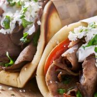 Gyro Wrap · Lamb and beef wrapped with lettuce, tomatoes, onions and sam's tzatziki sauce wrapped in tor...