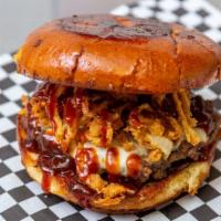The Big Brutus Burger · American cheese, bacon, onion straws, and bbq sauce.