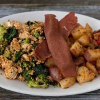 Vegan Tofu Scramble · Savory tofu scramble sauteed in spices and
olive oil and 2 veggies of your choice.