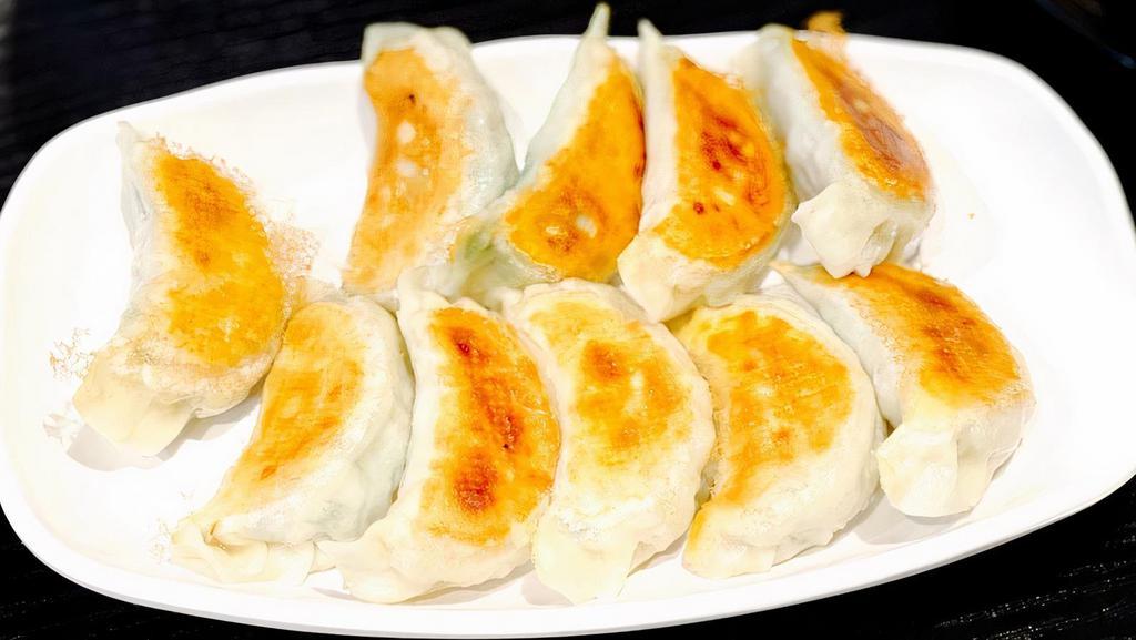 Pan Fried Dumplings · 10 pieces. Contains pork, shrimp, eggs, cabbage and chives