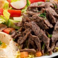 Beef Shawarma · Lean beef seasoned sliced and marinated over night then served with rice, hummus and fattoush.
