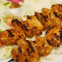 Chicken Kabob · Marinated and char-grilled chicken breast, served with rice and vegetables.