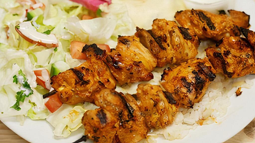 Chicken Kabob · Marinated and char-grilled chicken breast, served with rice and vegetables.