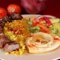 Lamb Kabob · Tender lamb marinated overnight, served with rice hummus salad and vegetables grilled to per...