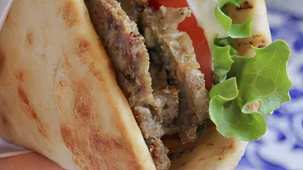 Gyro Sandwich · Beef and lamb meat on pita bread, tomato, onion, lettuce, topped with yogurt and cucumber sauce with feta cheese.