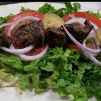 Beef Kabob Wrap · Char-grilled tender beef served with seasoned onions, tomatoes, pickles and lettuce.