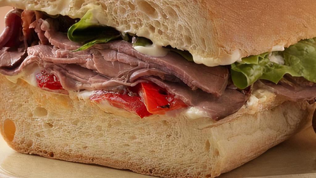 Roast Beef Sandwich · Roast beef, cheese, mayo, mustard, lettuce, tomato, onions, pickles on a French roll.