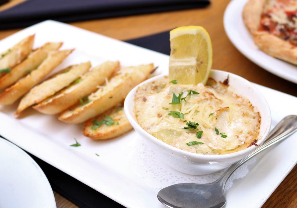 Crab And Artichoke Dip · Served with baked crostini