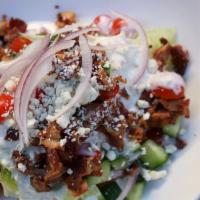 Classic Wedge · Cherry tomatoes, red onion, cucumber, bacon, blue cheese crumbles with blue cheese dressing.