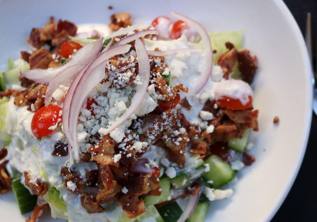 Classic Wedge · Cherry tomatoes, red onion, cucumber, bacon, blue cheese crumbles with blue cheese dressing.