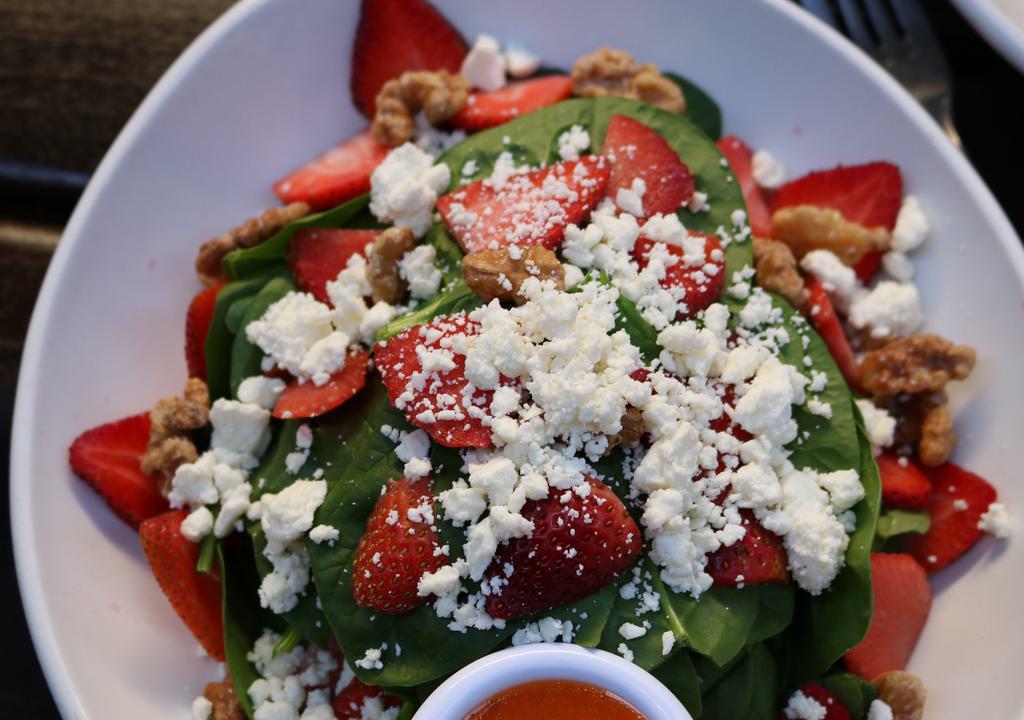 Rc Spinach · Vegetarian. Tender baby spinach, feta cheese, candied walnuts, strawberries with blood orange vinaigrette.
