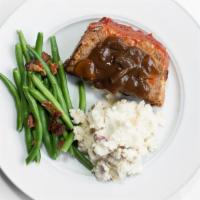 Grandma'S Meatloaf · House made meatloaf covered with mushroom gravy and served with mashed red potatoes and roas...