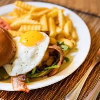 The Hangover · Crispy bacon, egg sunny-side up, cheddar cheese, arugula and chipotle ketchup.